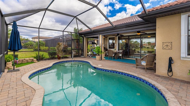 view of swimming pool featuring a lanai, ceiling fan, and a patio area