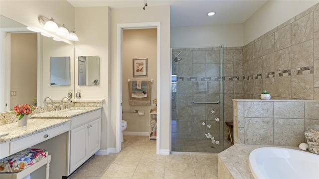 full bathroom featuring tile patterned flooring, vanity, shower with separate bathtub, and toilet