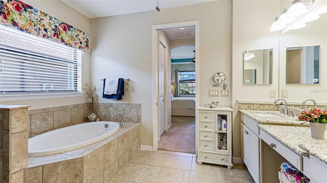 bathroom with tile patterned floors, ceiling fan, vanity, and a healthy amount of sunlight