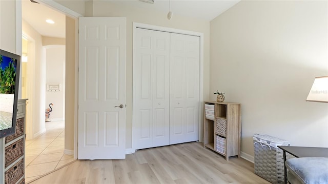 bedroom featuring a closet and light hardwood / wood-style flooring