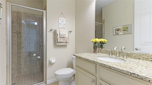 bathroom with vanity, an enclosed shower, and toilet