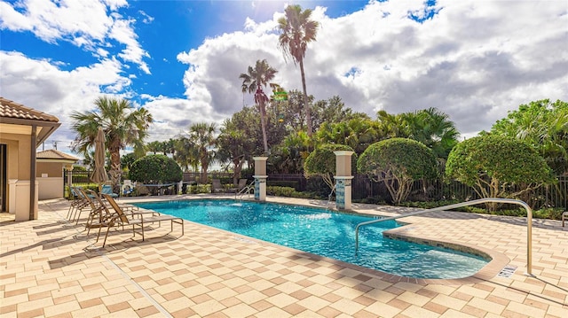 view of swimming pool with a patio and pool water feature