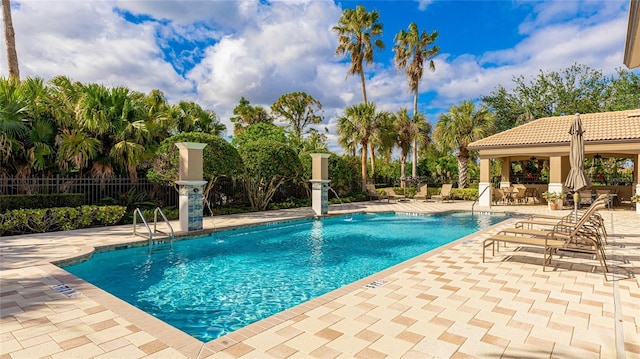 view of pool with a patio area and pool water feature