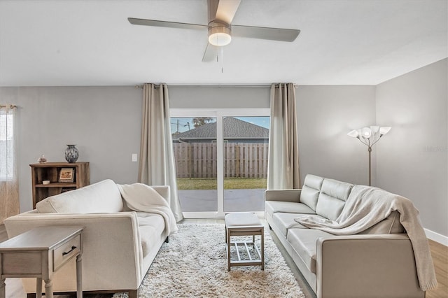 living room with ceiling fan and light hardwood / wood-style flooring