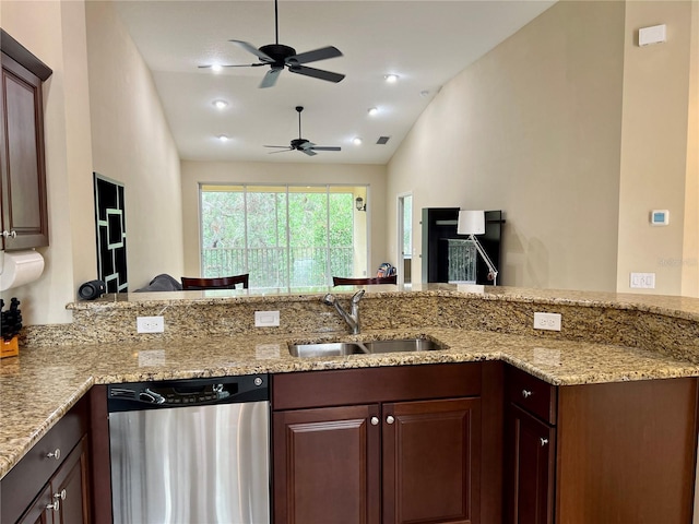 kitchen with kitchen peninsula, sink, stainless steel dishwasher, and lofted ceiling