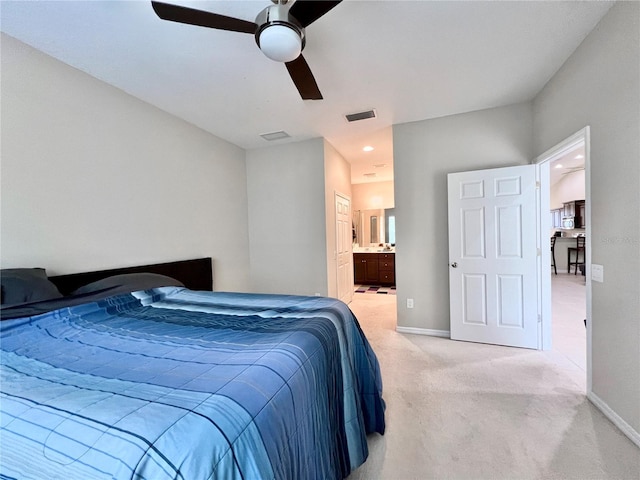 carpeted bedroom with connected bathroom and ceiling fan