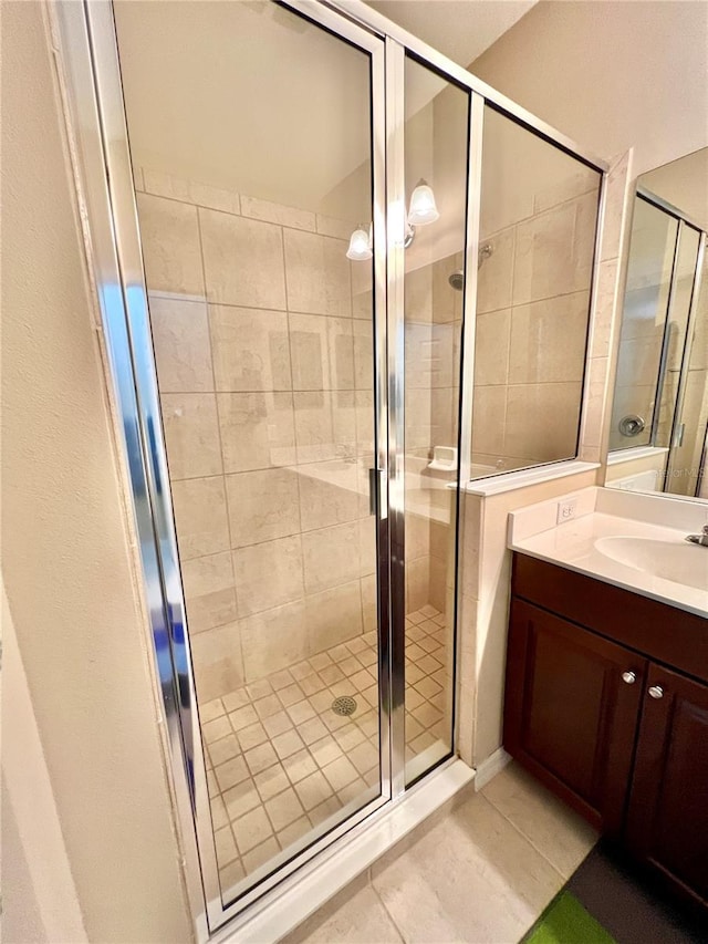 bathroom featuring vanity, tile patterned floors, and a shower with shower door