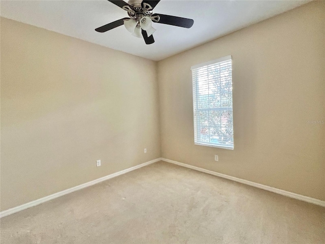 spare room featuring carpet and ceiling fan