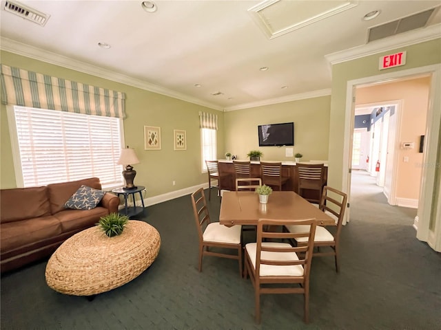 carpeted dining room featuring a healthy amount of sunlight and ornamental molding