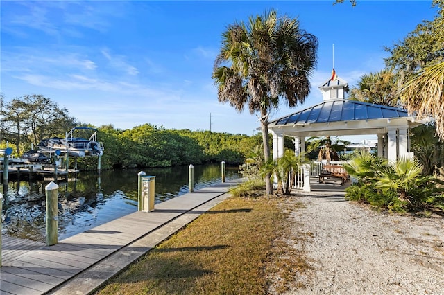 view of dock with a gazebo and a water view