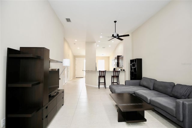 tiled living room featuring ceiling fan