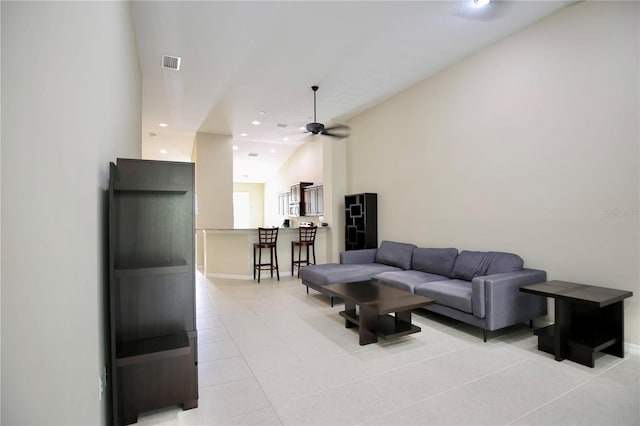 tiled living room with ceiling fan