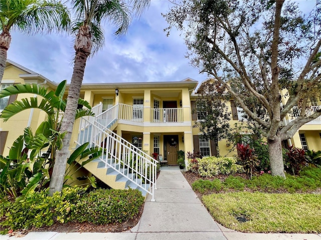 view of front of home featuring stairway and stucco siding