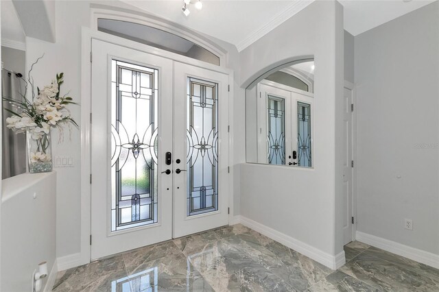 foyer with french doors and ornamental molding