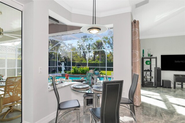 dining area with ceiling fan, crown molding, and a wealth of natural light