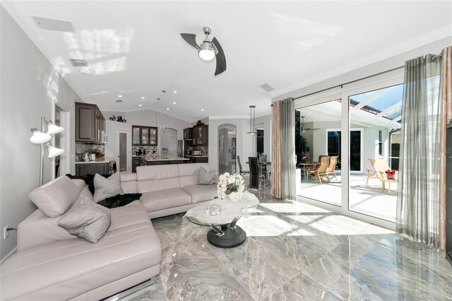 living room with ceiling fan, crown molding, and lofted ceiling