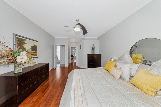 bedroom featuring ceiling fan, crown molding, and dark hardwood / wood-style floors