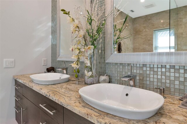 bathroom featuring vanity and backsplash