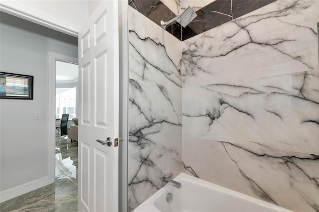 bathroom with shower / bathing tub combination and ornamental molding