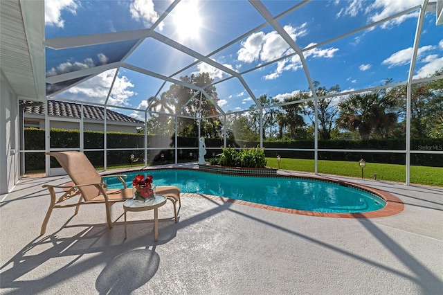 view of swimming pool with a patio and a lanai