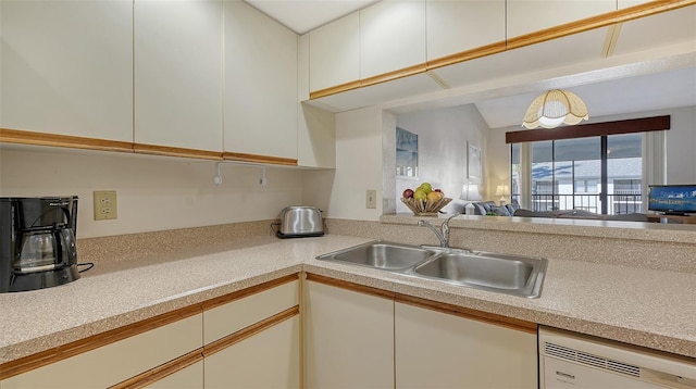 kitchen featuring white cabinetry, sink, and dishwasher