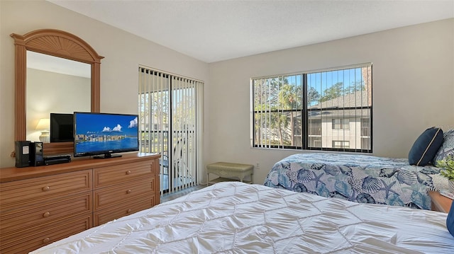 bedroom featuring a textured ceiling and multiple windows