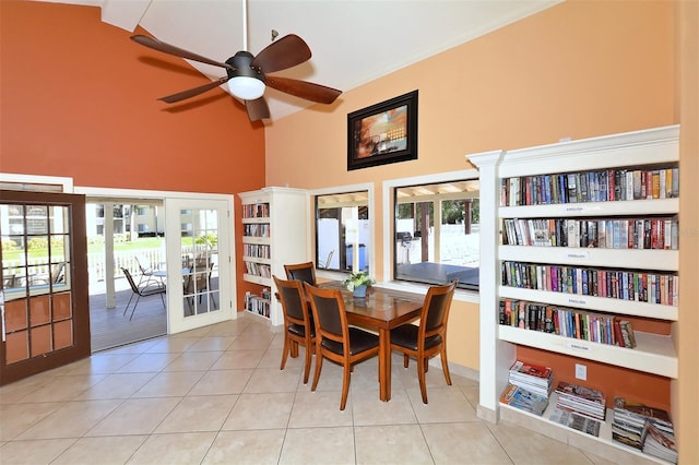 dining area featuring ceiling fan, french doors, a high ceiling, beamed ceiling, and light tile patterned floors