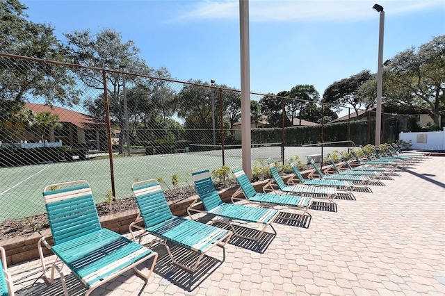 view of patio featuring tennis court