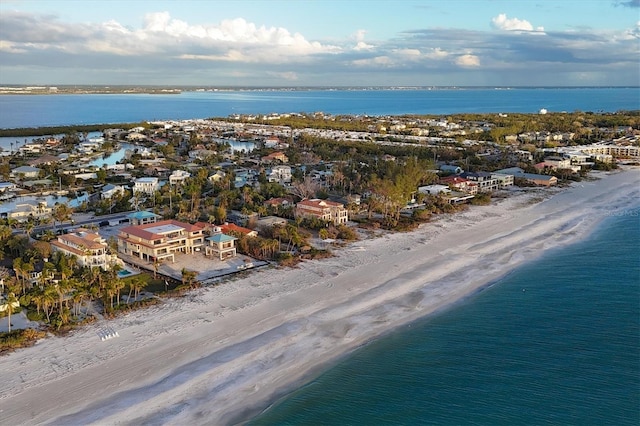 drone / aerial view featuring a beach view and a water view