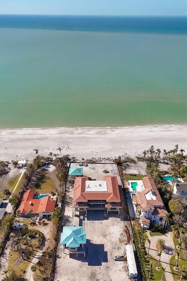 drone / aerial view featuring a water view and a beach view