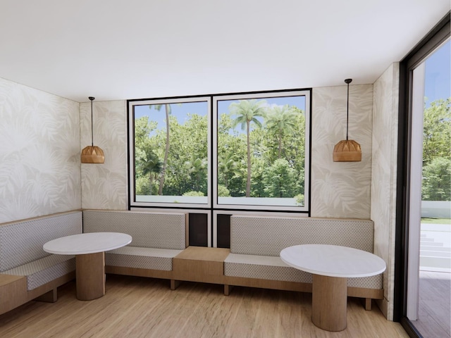 bathroom with wood finished floors and wallpapered walls