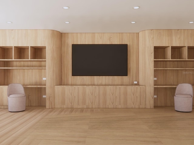 unfurnished living room with wood finished floors and recessed lighting