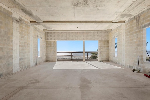 unfurnished room with concrete flooring