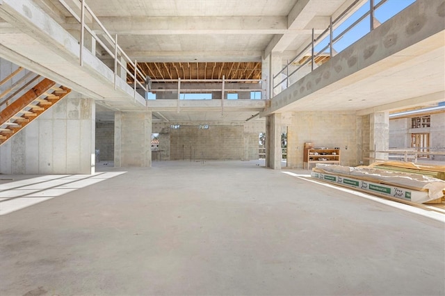 interior space with a high ceiling and concrete flooring