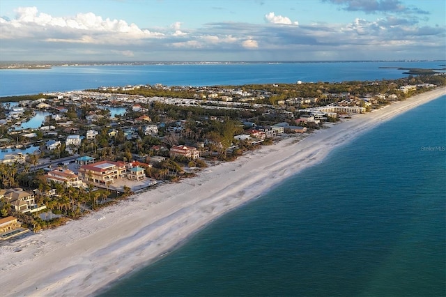 birds eye view of property with a water view and a view of the beach