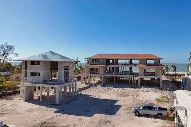 rear view of property with a water view