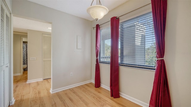 unfurnished bedroom with light hardwood / wood-style floors and a textured ceiling