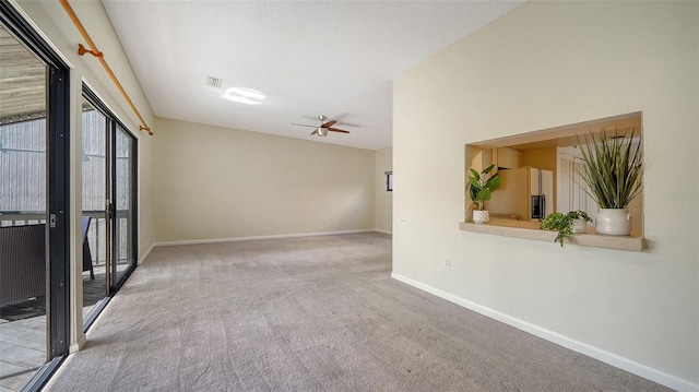 carpeted spare room with ceiling fan