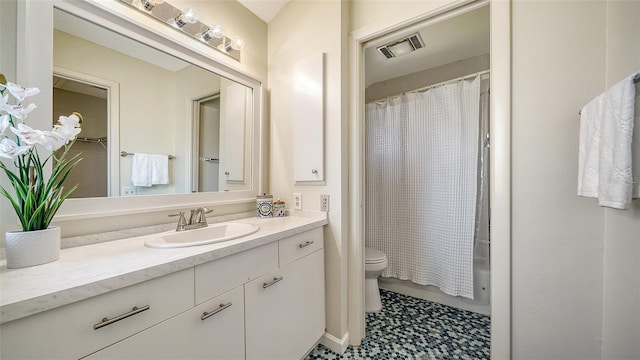 full bathroom with vanity, shower / tub combo, and toilet