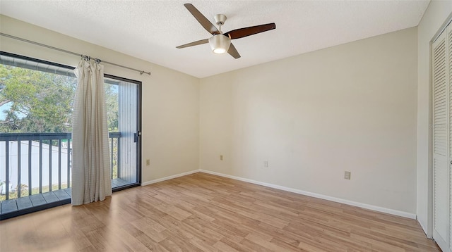 empty room with a textured ceiling, light hardwood / wood-style floors, and ceiling fan