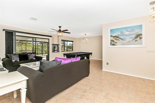 tiled living room with ceiling fan and billiards