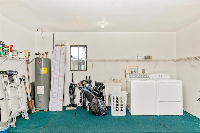 washroom with washing machine and clothes dryer and water heater