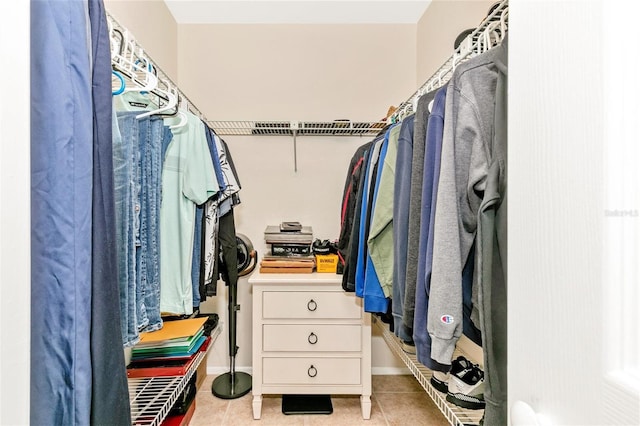 spacious closet featuring light tile patterned floors