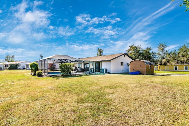 exterior space with a lanai, a yard, and a pool