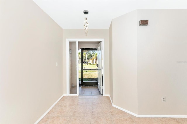 interior space with light tile patterned floors and baseboards