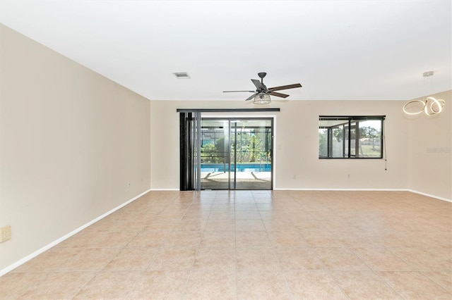 spare room with light tile patterned floors, baseboards, visible vents, and a ceiling fan