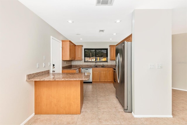 kitchen with stainless steel appliances, tasteful backsplash, visible vents, light tile patterned flooring, and a peninsula