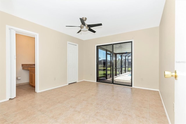 unfurnished bedroom featuring access to exterior, baseboards, and light tile patterned floors