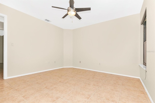 unfurnished room featuring light tile patterned floors, baseboards, visible vents, and a ceiling fan