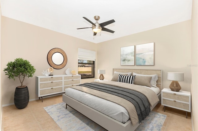 bedroom with light tile patterned floors, baseboards, and a ceiling fan